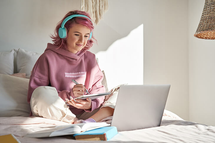 Girl studying on bed